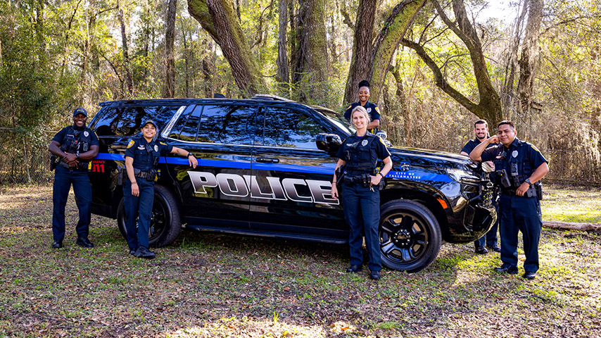 officers standing in front of a patrol vehicle