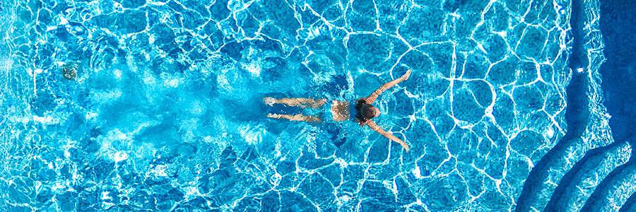 A single swimmer in a lovely pool